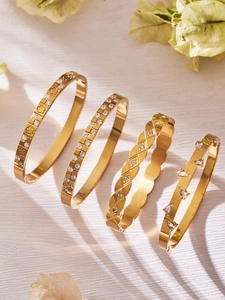 Detail view of 18k gold plated stainless steel bangles with zircon waterdrop and geometric inlay