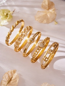 Detail of five assorted 18k gold plated stainless steel bangles with zircon inlay
