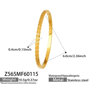 Close-up of golden quilted stainless steel bangle with zircon inlay and waterproof finish
