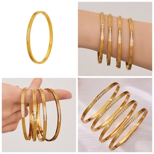 Detailed view of 18k gold plated stainless steel bangle with micro-pave zircon buckle