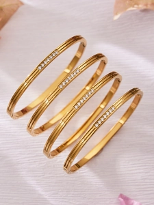 Detailed view of 18k gold plated stainless steel bangles with micro-pave cubic zirconia