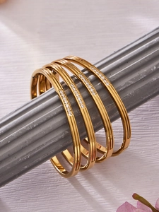 Detailed shot of four gold-plated 316L stainless steel bracelets with inlaid zircon stones