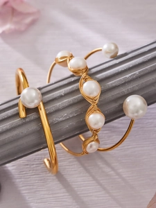 Primer plano del brazalete bañado en oro con hilo enrollado y perlas de agua dulce