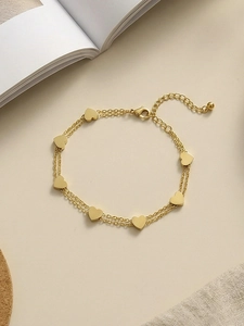 Detail of gold double-layer heart bracelet with lobster clasp and adjustable chain