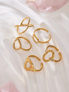 Detailed view of 5-piece gold stainless steel ring set with heart and geometric designs