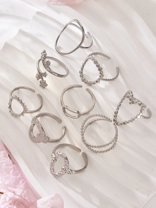 Detailed set of 9 adjustable silver rings with heart, floral, and minimalist designs