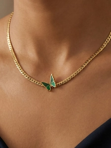 Detail view of a green enamel butterfly pendant on a gold plated stainless steel chain