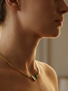 Detail of 18k gold plated Cuban chain necklace with green enamel butterfly pendant