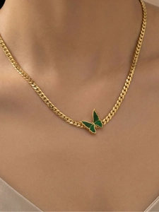 Close-up of a 18k gold-plated Cuban chain necklace with a green enamel butterfly pendant