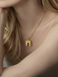 Detail of Arc de Triomphe pendant necklace in 18k gold plated steel on a female model