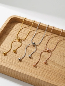 Detailed view of adjustable snake chain bracelets in gold, silver, and rose gold finishes