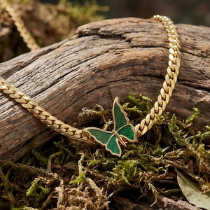 18k gold plated stainless steel butterfly necklace with green enamel on mossy wood
