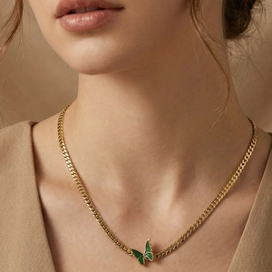 18k gold plated Cuban chain necklace featuring a green butterfly pendant on a model