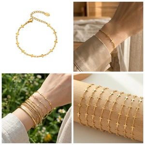 Detail of a gold stainless steel cross link bracelet with adjustable lobster clasp closure