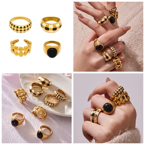 Detailed set of four gold-plated stainless steel rings with checkered enamel and black gem