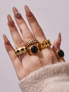 Close-up of luxury 18k gold plated checkered enamel rings and black gemstone rings