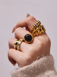 Close-up of retro 18k gold plated stainless steel checkered rings on hand