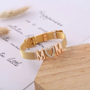 Detailed close-up of golden Milanese mesh bracelet featuring a sparkling MOM heart charm
