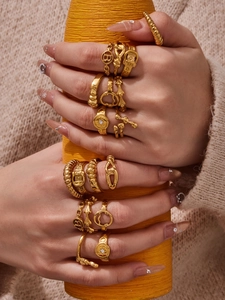 Detailed view of 12 gold plated geometric rings with diverse textures on fingers