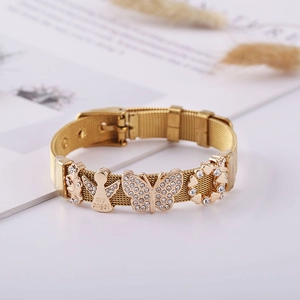 Detail of gold mesh bracelet with butterfly and heart charms with my angel engraving