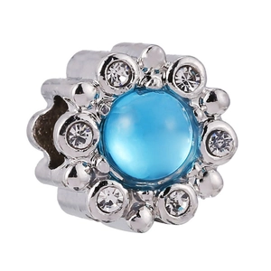 Macro view of flower charm bead with blue stone and white crystals for bracelets