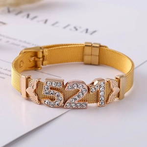 Golden mesh band bracelet featuring a sparkling 521 rhinestone charm with adjustable buckle