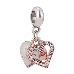 Detailed view of dual-heart charm with rose gold hollow heart and silver engraved back