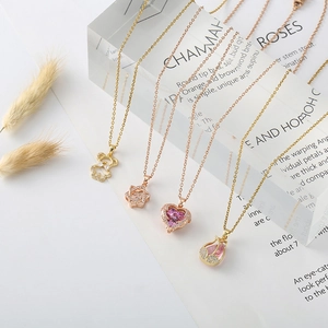 Chic gold-plated necklaces featuring bear, heart, and flower pendants with pink zircon stones