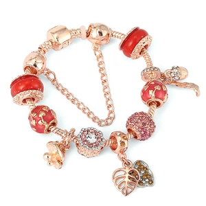 Bracelet à breloques en or rose avec perles en verre rouge et pendentifs cœur étincelants