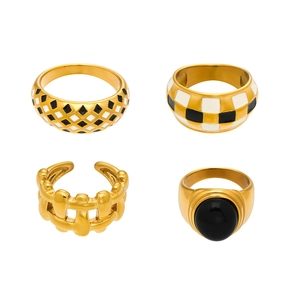 Set of four 18k gold plated stainless steel rings with checkered enamel and black gems