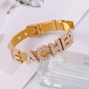 Detail view of golden mesh band bracelet with sparkling TEACHER rhinestone letters