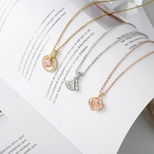 Detailed view of three elegant necklaces featuring circular, fan, and heart zircon pendants