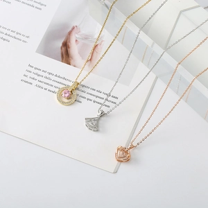 Detail of bear necklaces in gold, silver, and rose gold with heart and fan pendants