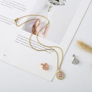 Macro detail of bear pendant necklace with zircon and shell pearl on magazine background