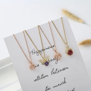 Detailed view of four elegant zircon inlaid necklaces with shell pearl and bird motifs