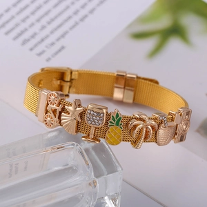Golden mesh bracelet with tropical vacation charms like palm tree and pineapple