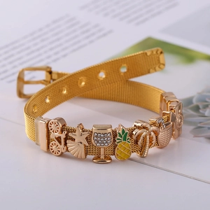 Detail of gold mesh band bracelet with pineapple, palm tree and camera charms