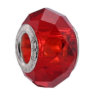 Macro shot of a red faceted crystal bead with a 925 sterling silver core charm