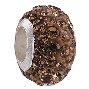 Macro detail of brown crystal clay bead with 4 rows of amber rhinestones for DIY bracelets