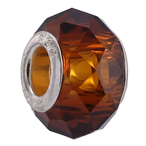 Macro detail of amber faceted crystal bead with S925 sterling silver engraved core