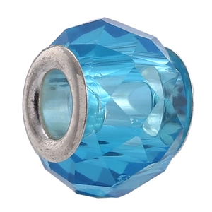 Macro shot of faceted blue crystal charm bead with silver metal core for DIY bracelet
