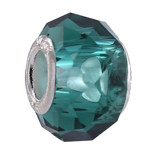 Macro detail of dark green faceted crystal bead with embossed silver metal core for DIY