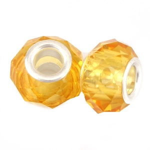 Detail of amber faceted crystal charm beads with silver metal cores for DIY jewelry