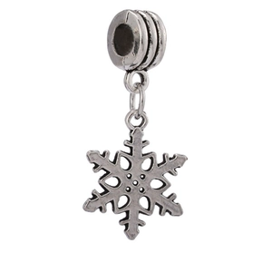 Macro shot of silver vintage snowflake charm with large hole for DIY jewelry making