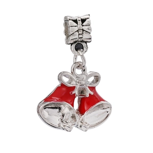 Detail of silver-plated Christmas bell charm with red glaze and a decorative bow design