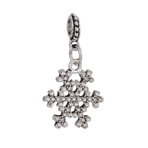 Macro shot of silver snowflake charm with sparkling rhinestones for DIY jewelry making