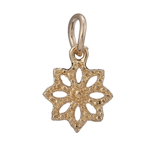 Detailed macro view of a gold-plated snowflake pendant with beaded edges and top ring
