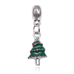 Detailed view of a green enamel Christmas tree charm with red dots and silver finish