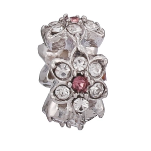Close-up of a silver flower charm bead with pink gemstone and zircon inlay detailing