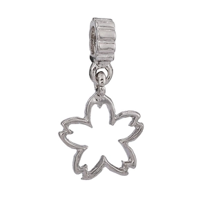 Close-up of a silver hollow cherry blossom charm with large textured ring for DIY jewelry
